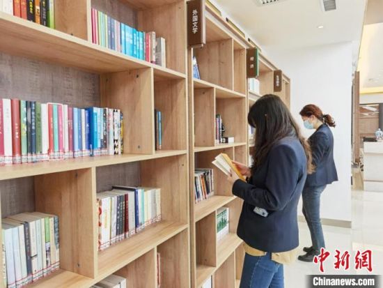 圖為在甘肅公航旅建設集團有限公司的職工書屋，職工挑選書籍?！⌒煅?攝